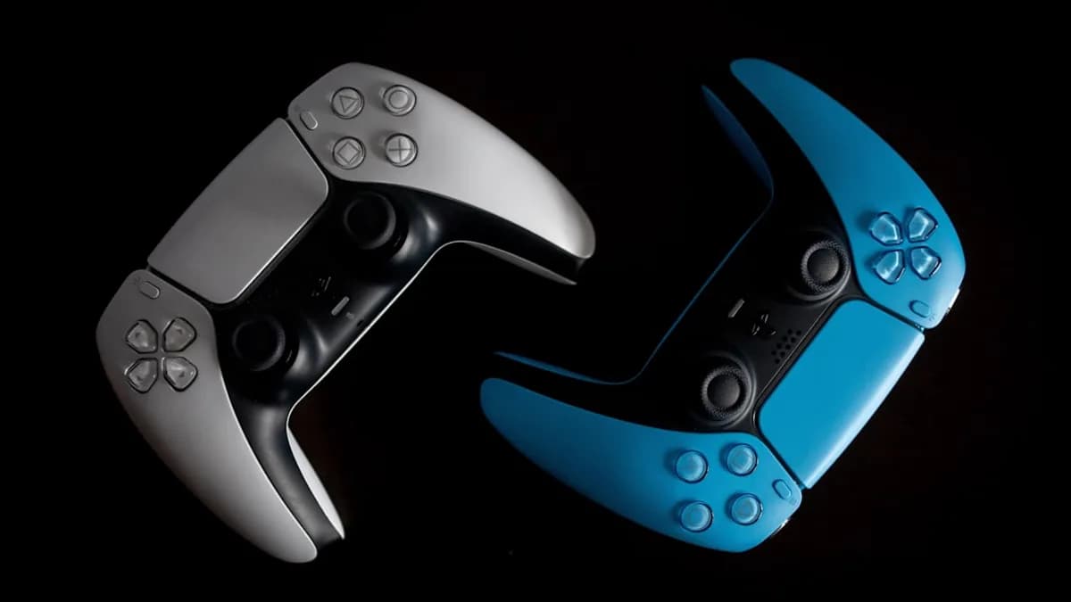 two video game controllers sitting side by side