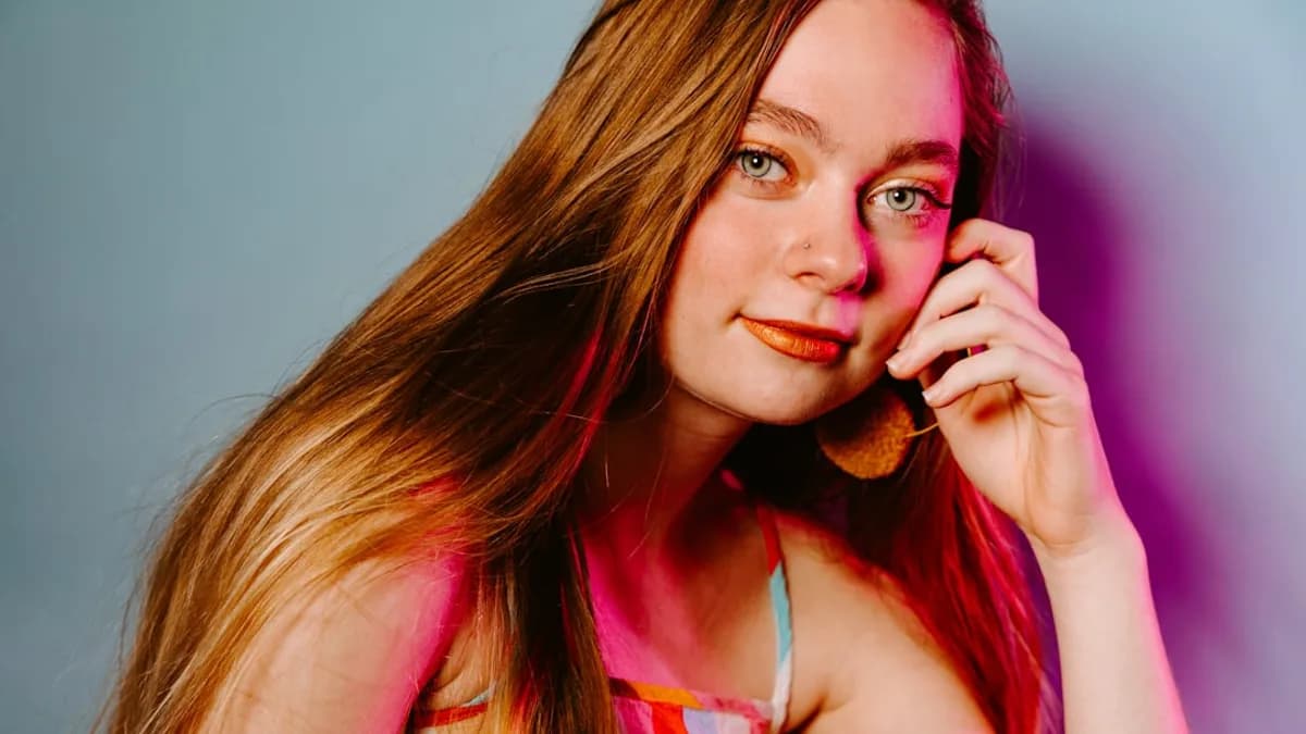 woman in pink and white tank top holding brown dried leaf