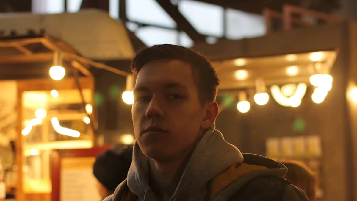 man in brown jacket standing