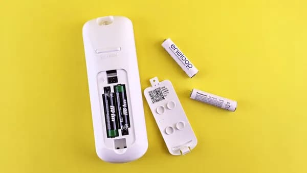 A couple of remote controls sitting on top of a table