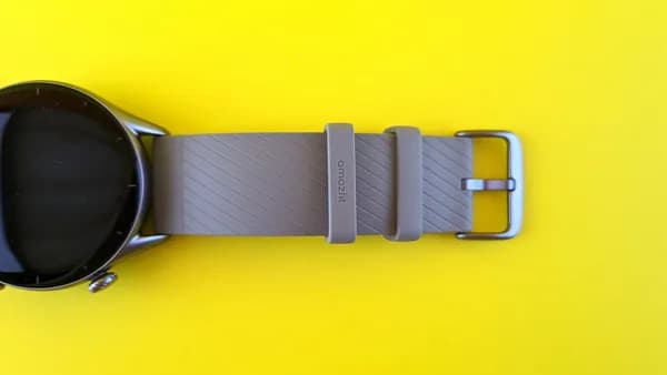 a smart watch sitting on a yellow surface