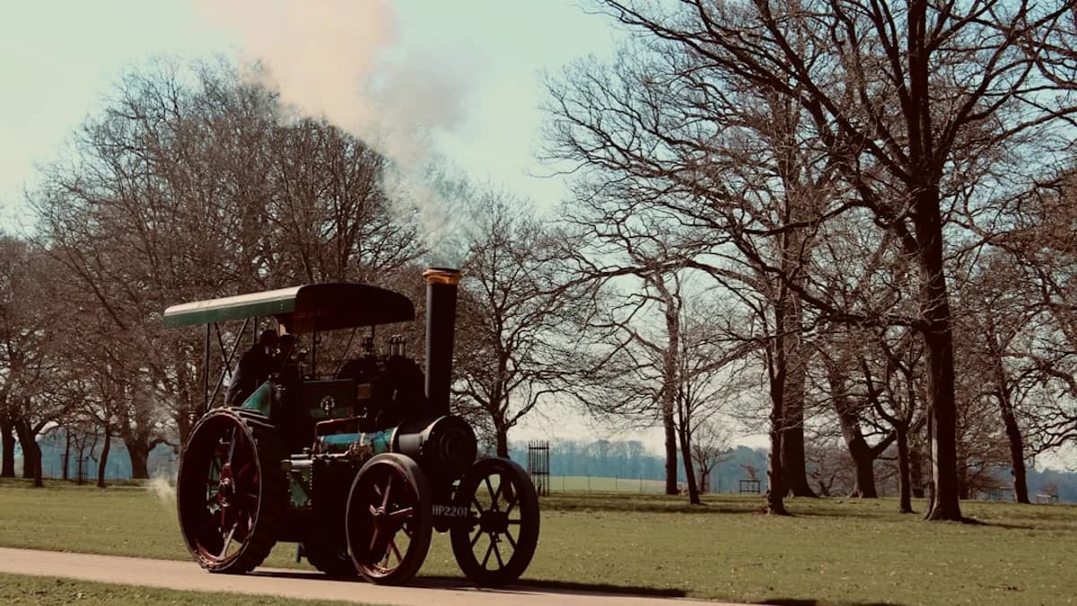 a tractor is driving down the road in a park