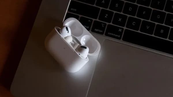 white apple earpods on gray laptop computer