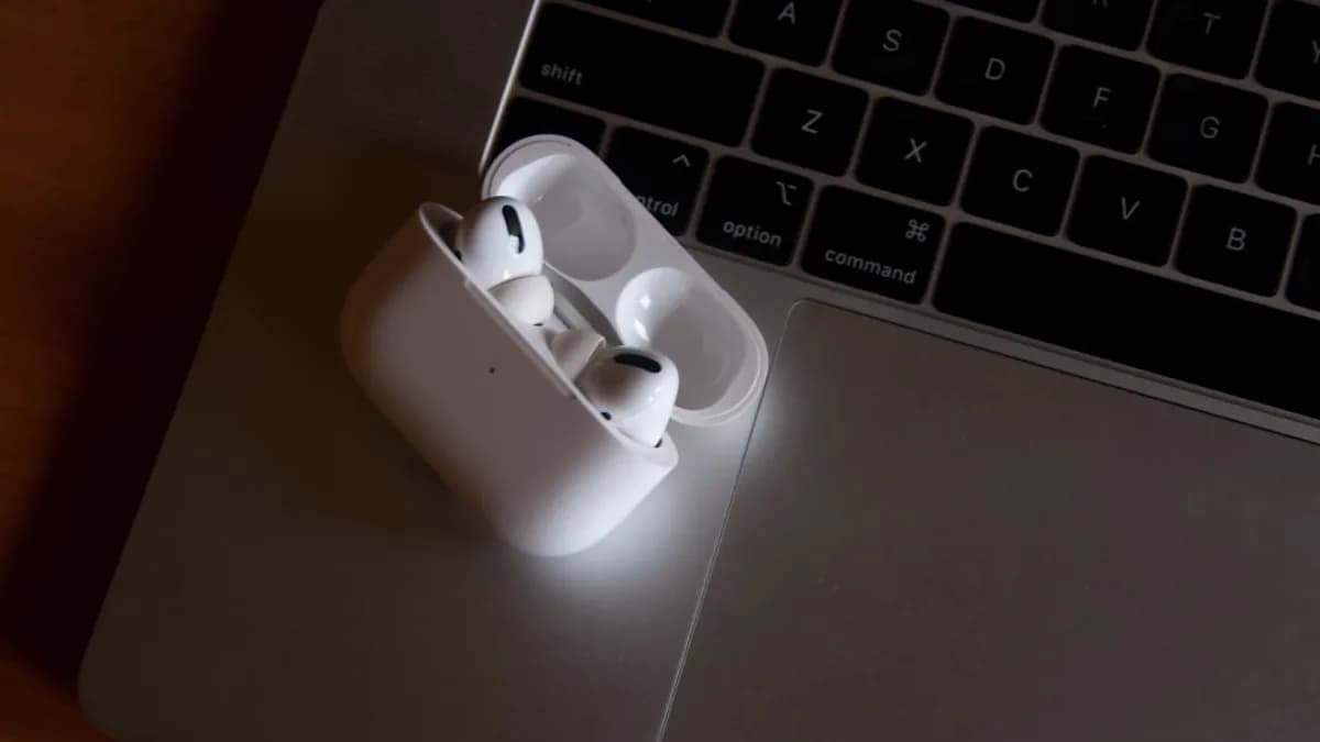 white apple earpods on gray laptop computer