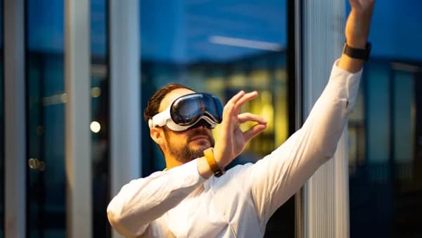 a man in a white shirt wearing a pair of virtual glasses