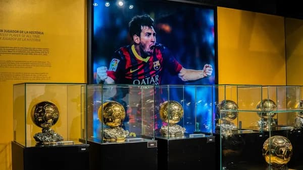 a person standing behind trophies