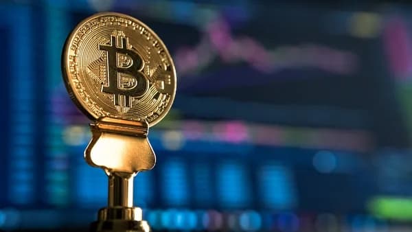 selective focus photo of Bitcoin near monitor
