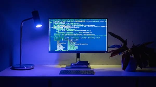 Code appears on a computer screen.