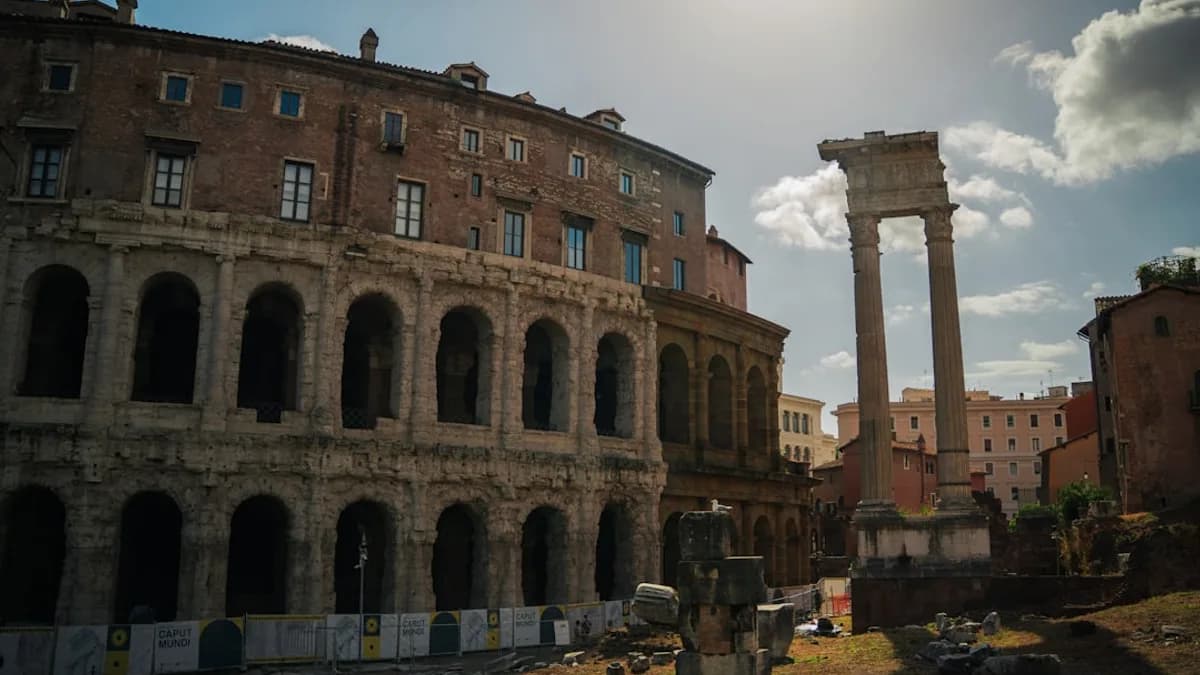 Ancient roman ruins stand under a sunny sky.