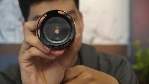 person holding black camera lens