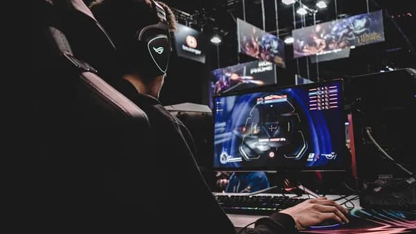 person sitting on gaming chair while playing video game