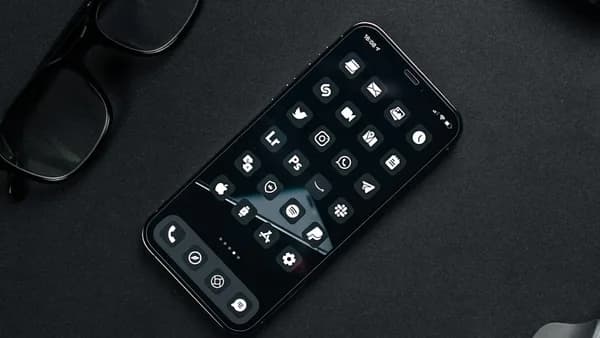 black remote control beside black framed eyeglasses