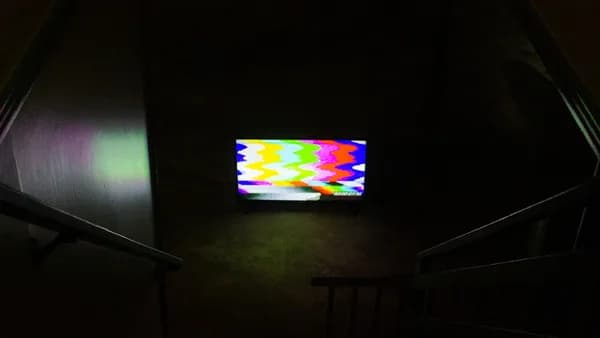 black flat screen tv turned on displaying soccer game