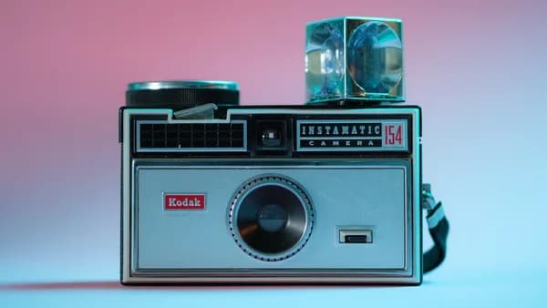 black and silver camera on white table