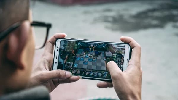 a man is playing a game on his phone