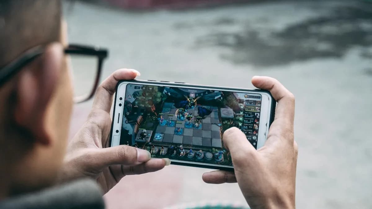 a man is playing a game on his phone