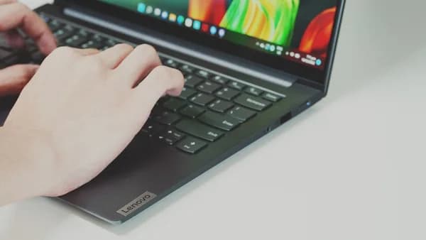 Person typing on a laptop keyboard
