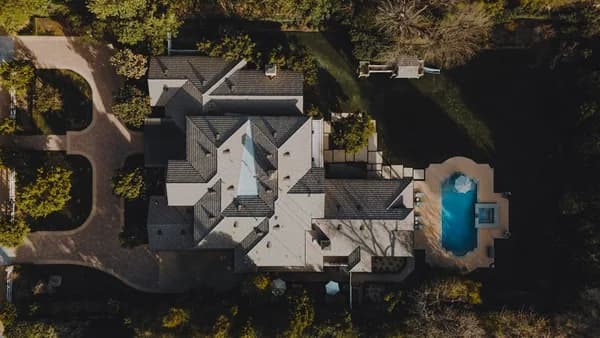 an aerial view of a house in the woods