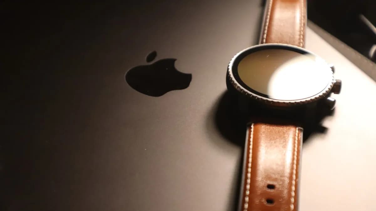 brown leather strap on silver macbook
