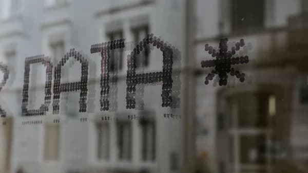 a close up of a window with a building in the background