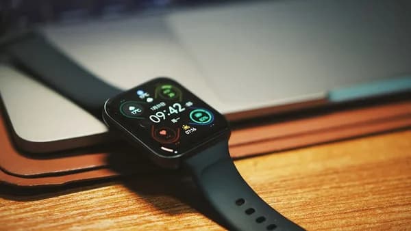 a smart watch sitting on top of a wooden table