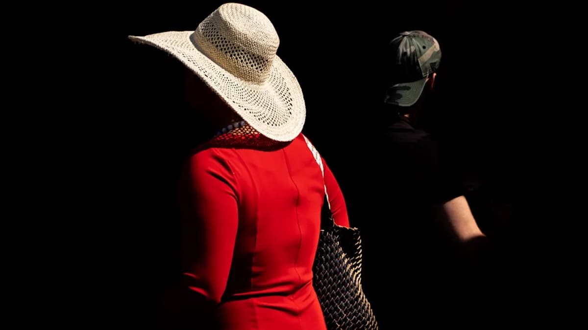 woman in red long sleeve dress wearing white and black hat