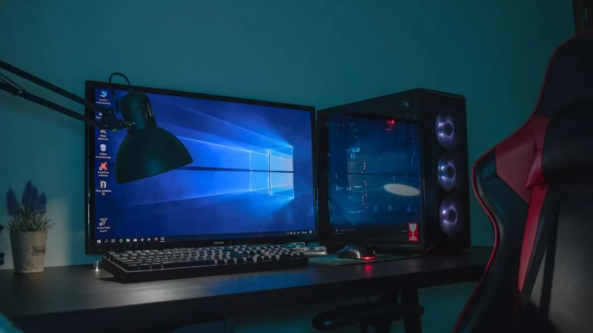 turned on desktop computer set with black and gray leather gaming chair