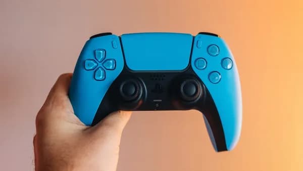 a person holding a blue video game controller