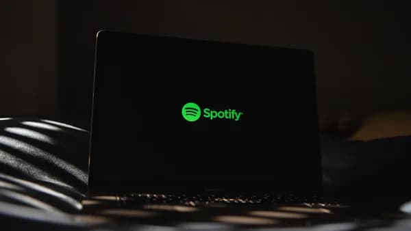 a laptop computer sitting on top of a bed