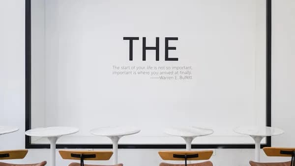 a group of chairs sitting in front of a white wall