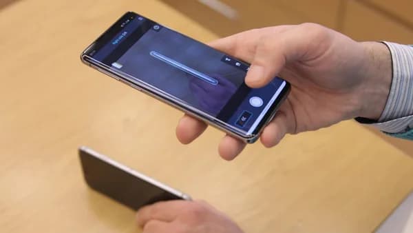 a person holding a cell phone in their hand
