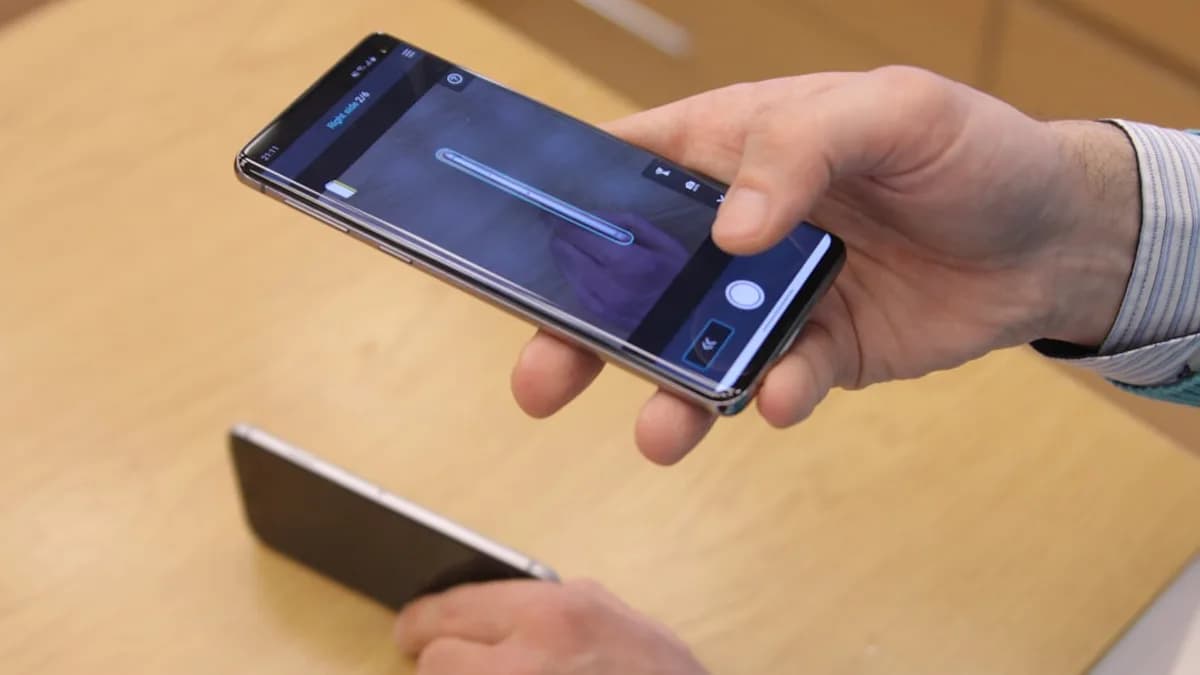 a person holding a cell phone in their hand