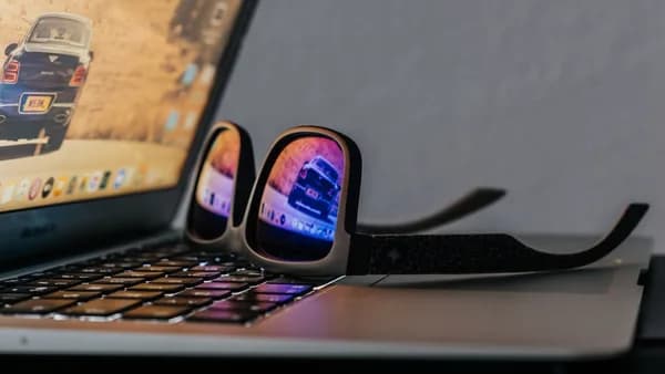 black smartphone on black laptop computer