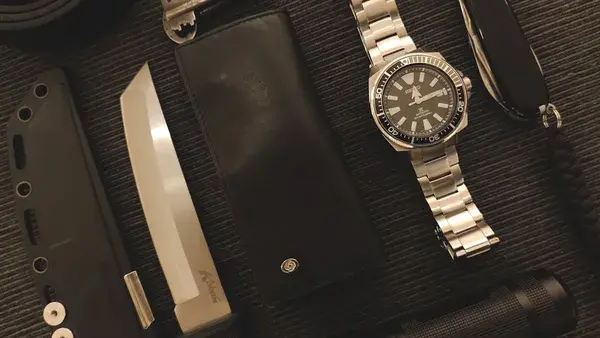 Everyday carry items on a textured surface.