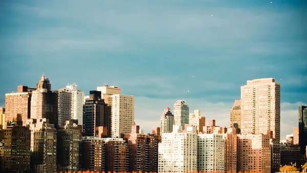 concrete buildings under cloudy sky