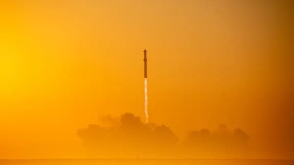 a rocket is flying through the air on a foggy day