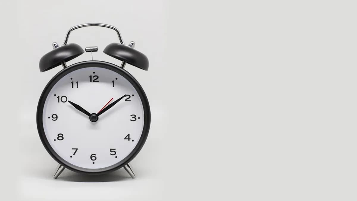 a black and white alarm clock on a white background