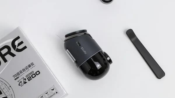 A camera and accessories laid out on a table