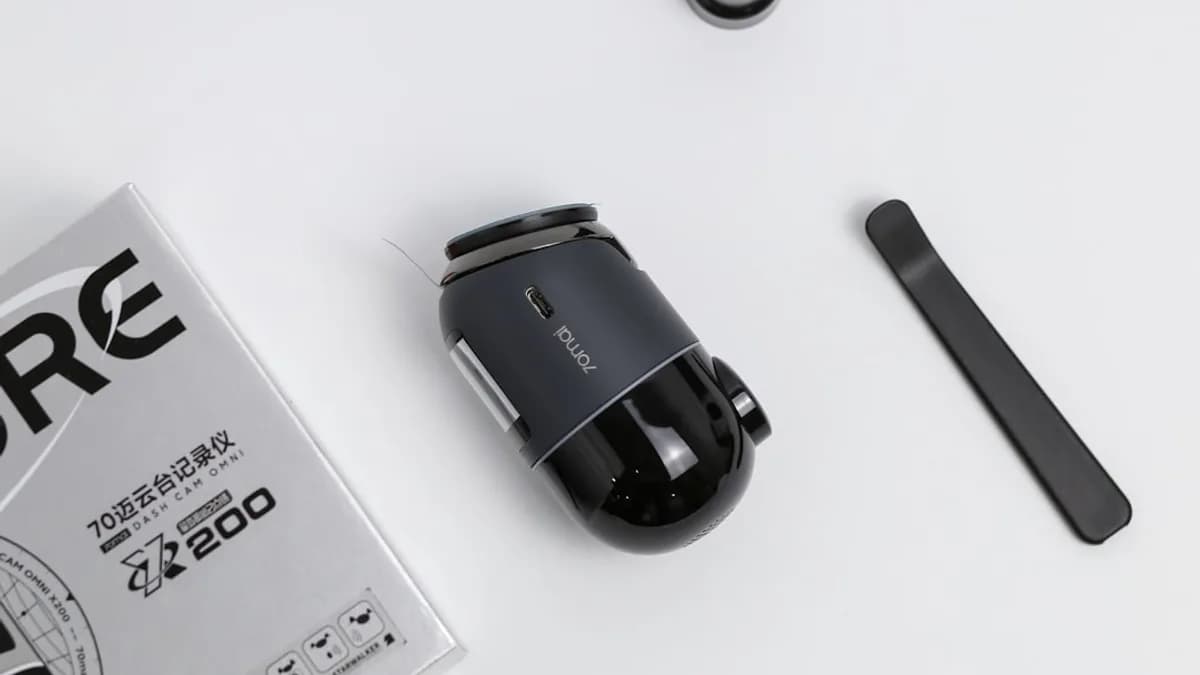 A camera and accessories laid out on a table