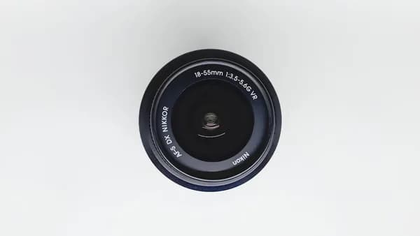 black camera lens on white surface