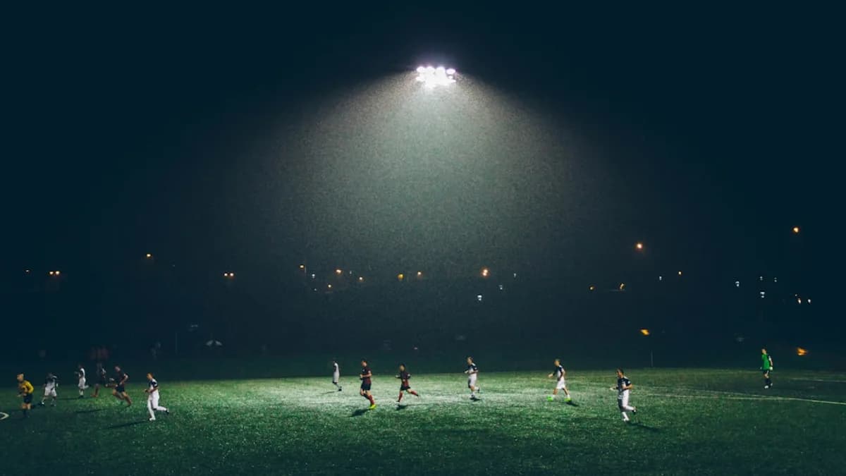 group of people playing soccer on soccer field