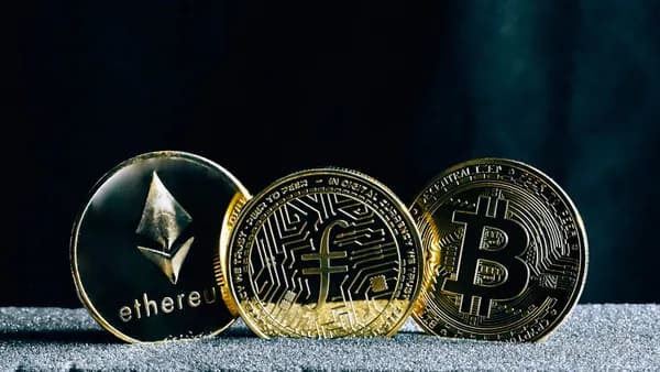 three bitcoins sitting on top of a table