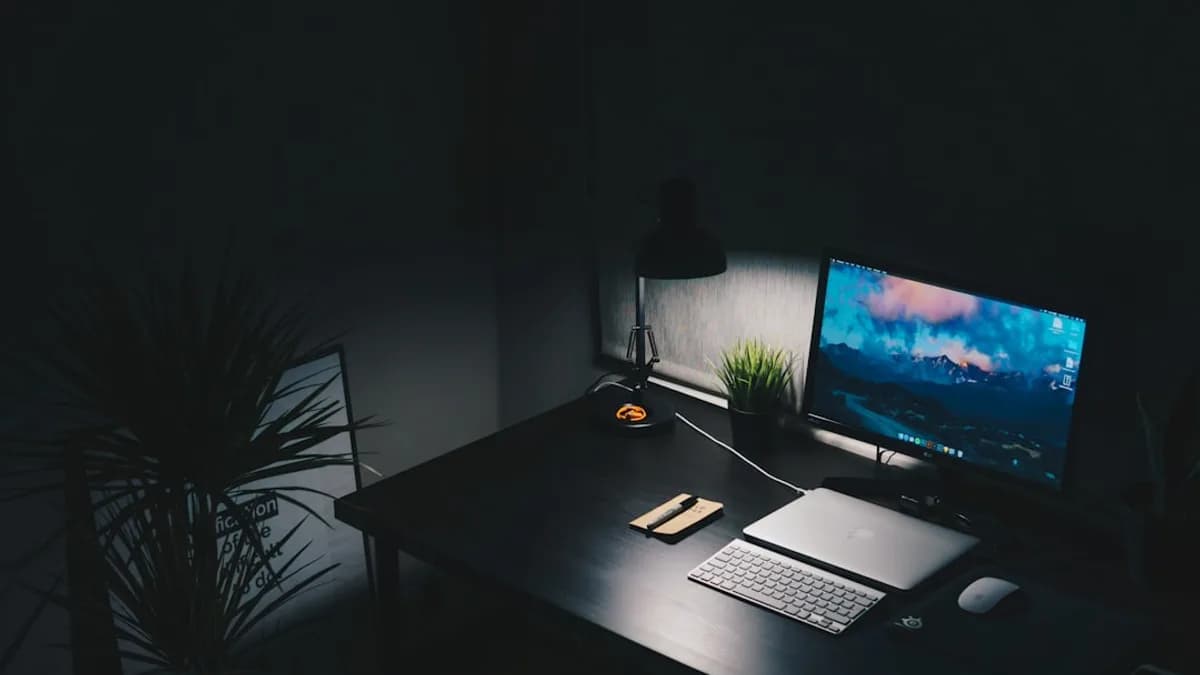 a desk with a computer monitor and keyboard on it