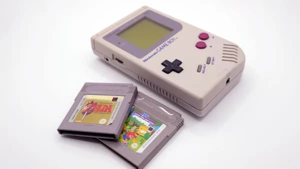 a nintendo game boy with a card and a case