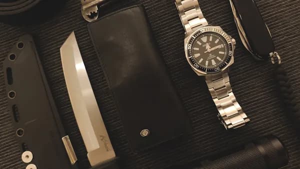 Everyday carry items on a textured surface.