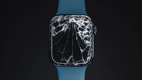 An apple watch with a cracked glass case