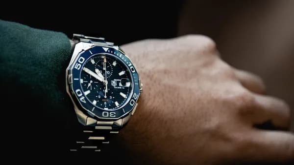 round black chronograph watch at 5:50