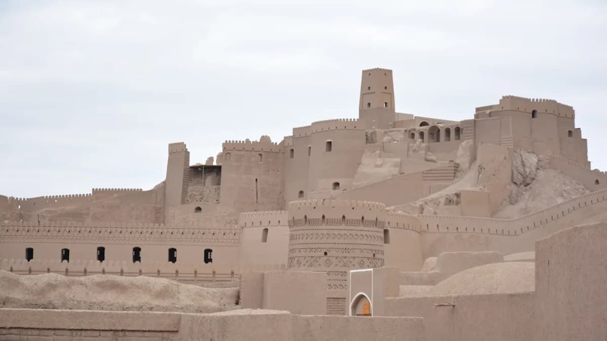 Ancient desert fortress with towers under a cloudy sky