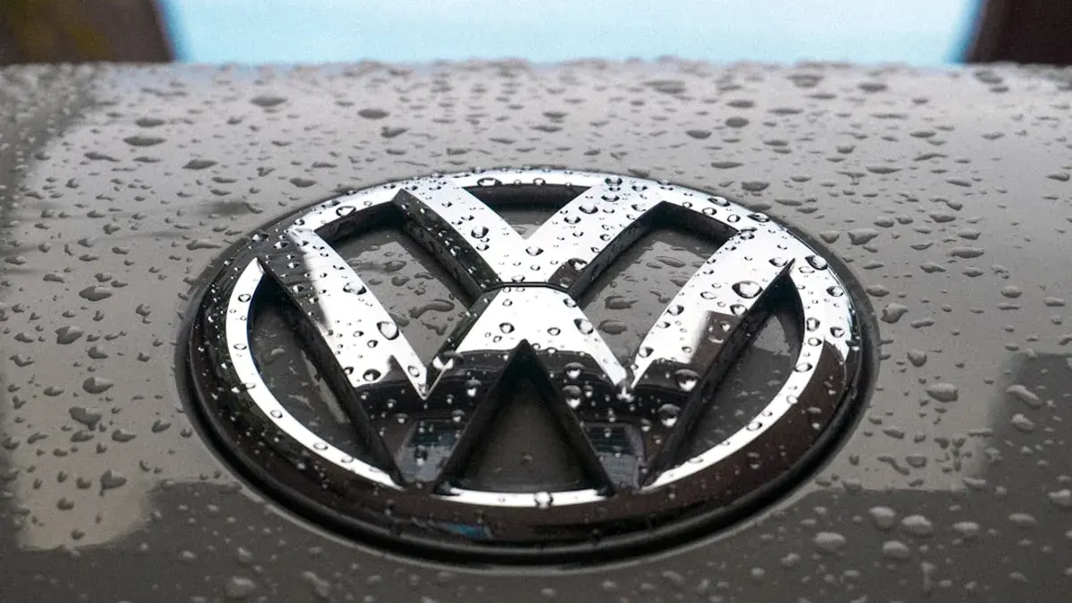 water dew on silver Volkswagen car emblem