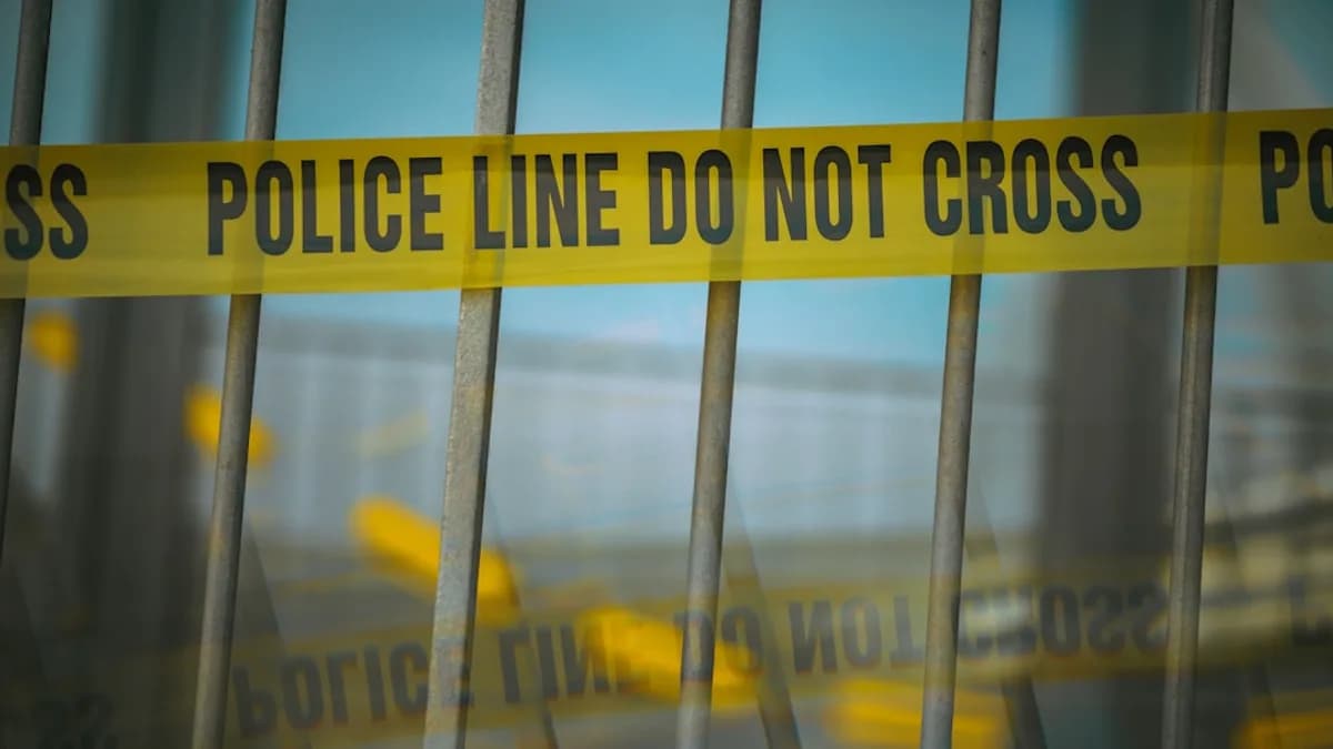 a close up of a yellow police line behind bars